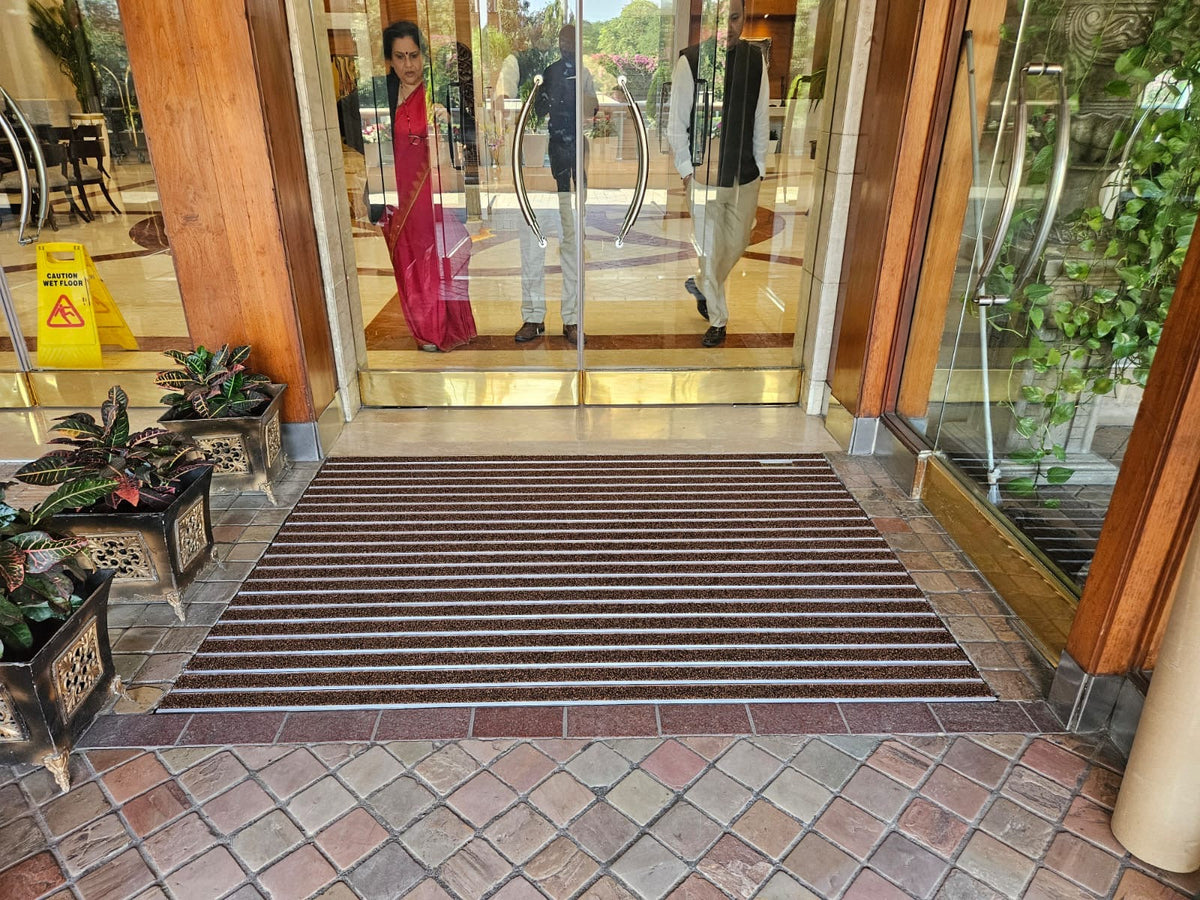 Ultimats aluminium entrance mat with carpet inserts at a hotel doorway